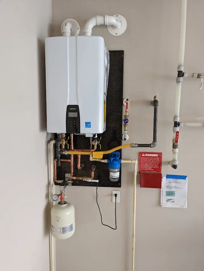 Professional plumber installing copper piping in a Fallsburg home